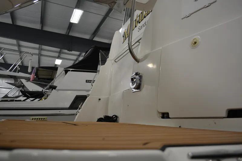 Slide: The Image of 2001 Silverton 453 Motor Yacht in indoor storage, showcasing rear deck and sleek design. - 8