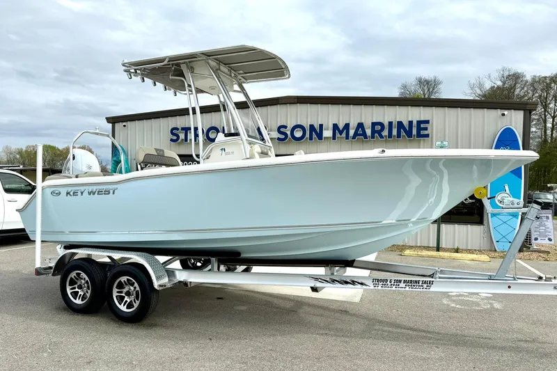 Slide: The Image of 2025 Key West 203 FS boat on trailer at dealership, side view. - 1
