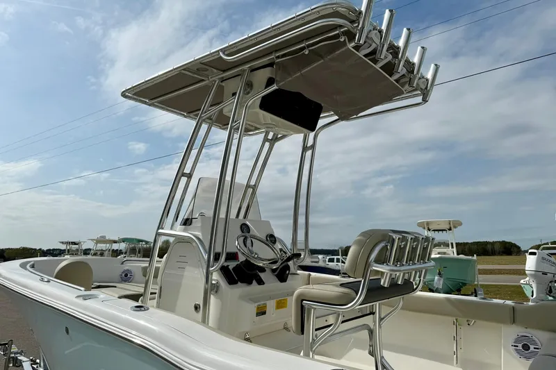 Slide: The Image of 2025 Key West 203 FS boat with T-top and seating, under a clear sky. - 12