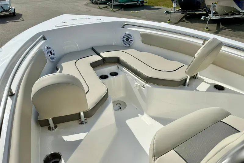 Slide: The Image of 2025 Key West 203 FS boat interior with cushioned seating and cup holders. - 13
