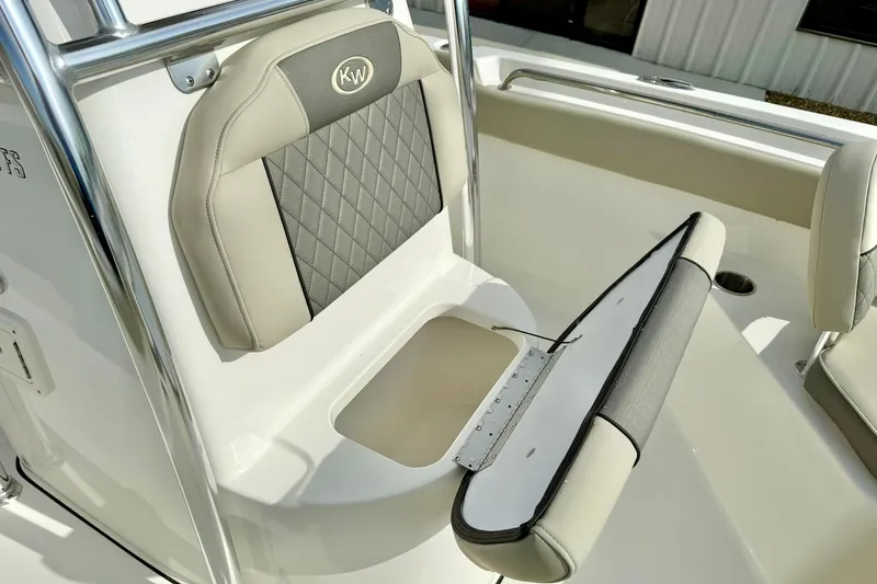 Slide: The Image of 2025 Key West 203 FS boat seat with storage compartment, featuring diamond-patterned upholstery. - 19