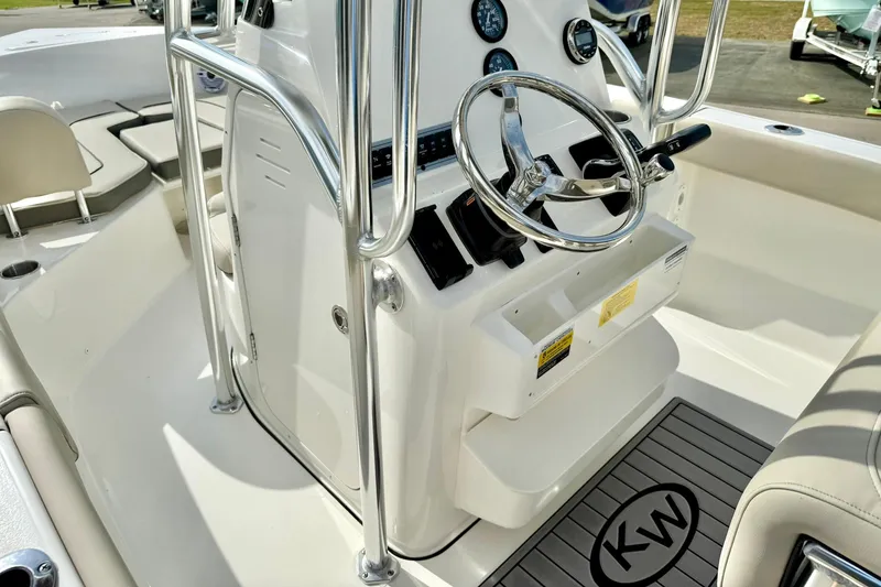 Slide: The Image of 2025 Key West 203 FS boat interior with steering wheel and control panel. - 22