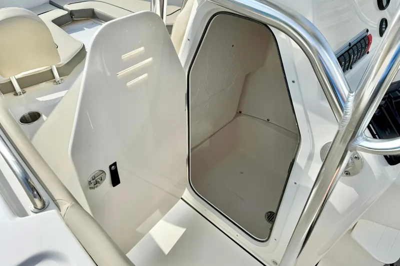 Slide: The Image of 2025 Key West 203 FS boat interior storage compartment with open door. - 23
