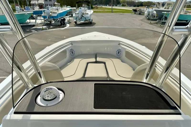 Slide: The Image of 2025 Key West 203 FS boat interior with seating and console, docked at marina. - 24