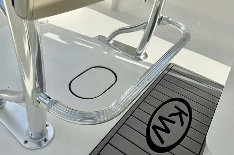 Slide: The Image of 2025 Key West 203 FS boat interior with metal footrest and KW logo mat. - 26
