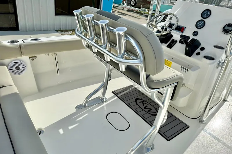 Slide: The Image of 2025 Key West 203 FS boat interior with helm, rod holders, and seating. - 27