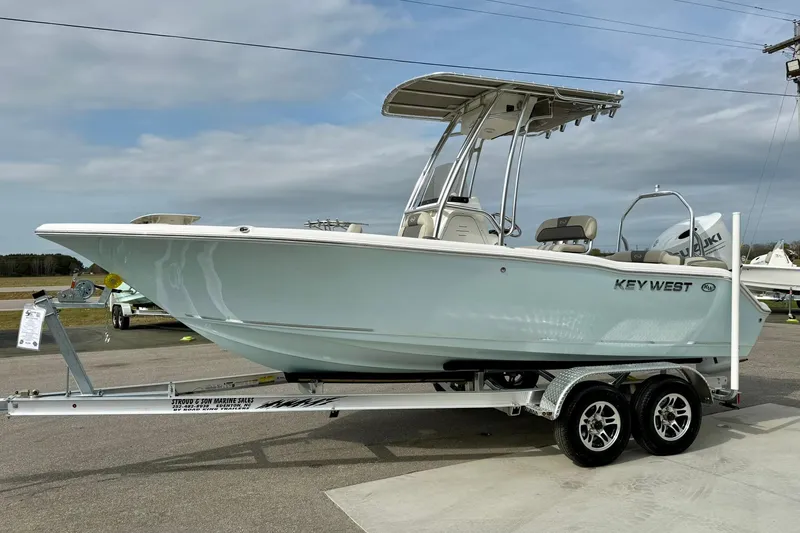 Slide: The Image of 2025 Key West 203 FS boat on trailer, parked outdoors under cloudy sky. - 5