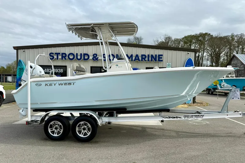 Slide: The Image of 2025 Key West 203 FS boat on trailer outside Stroud & Son Marine dealership. - 6