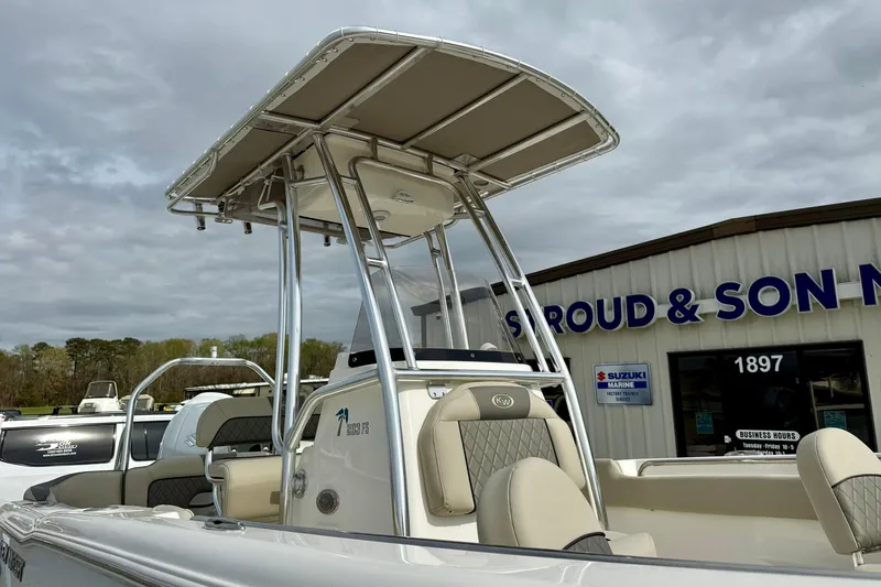 Slide: The Image of 2025 Key West 203 FS boat with T-top, parked outside dealership. - 9