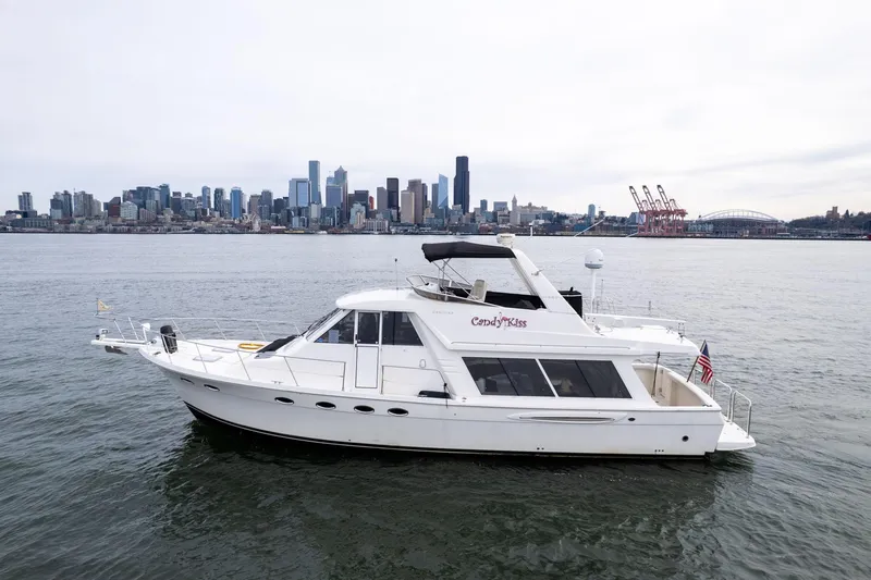 The Image of 2003 Meridian 490 Pilothouse yacht on water with city skyline in background. - 0