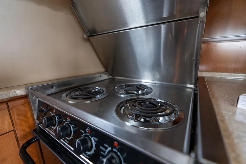 Slide: The Image of Stainless steel stove with three burners in a 2003 Meridian 490 Pilothouse yacht kitchen. - 11