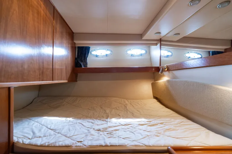 Slide: The Image of Cozy cabin interior of 2003 Meridian 490 Pilothouse with wood accents and porthole windows. - 18