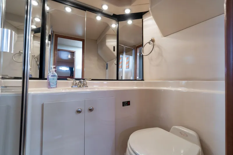 Slide: The Image of Bathroom interior of 2003 Meridian 490 Pilothouse yacht, featuring sink, mirror, and toilet. - 20