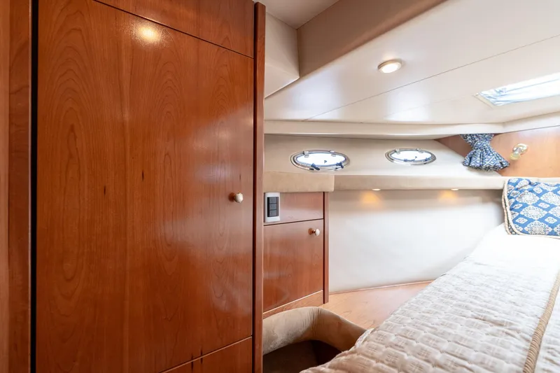 Slide: The Image of Luxurious cabin interior of 2003 Meridian 490 Pilothouse yacht with wood finish and portholes. - 28