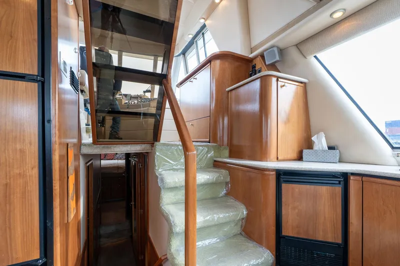 Slide: The Image of Interior of 2003 Meridian 490 Pilothouse with wooden cabinetry and carpeted stairs. - 35