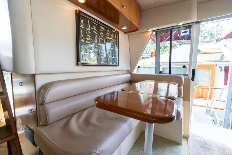 Slide: The Image of 2003 Meridian 490 Pilothouse interior with dining area and nautical decor. - 36