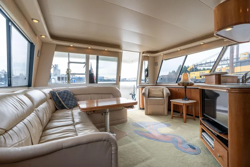 Slide: The Image of Luxurious interior of 2003 Meridian 490 Pilothouse yacht with leather seating and panoramic windows. - 4