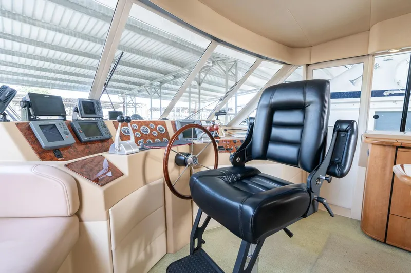 Slide: The Image of Pilothouse interior of 2003 Meridian 490, featuring steering wheel and navigation instruments. - 40