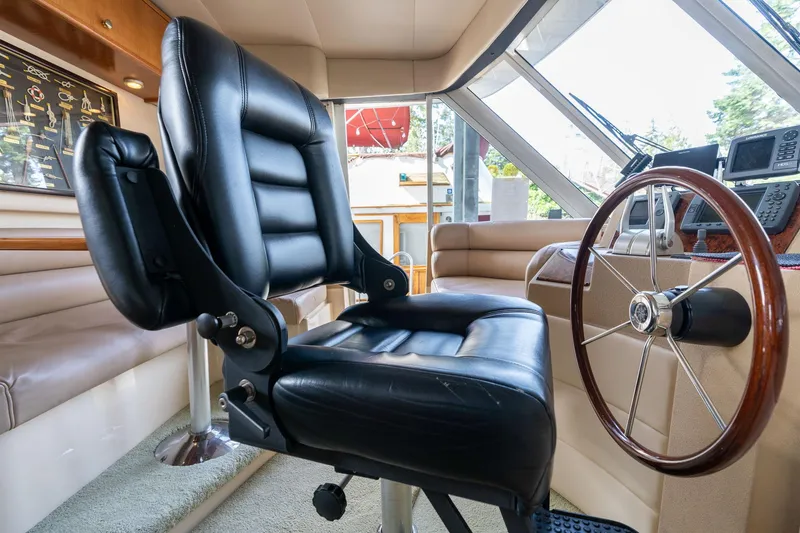 Slide: The Image of Captain's chair and helm in 2003 Meridian 490 Pilothouse yacht interior. - 41