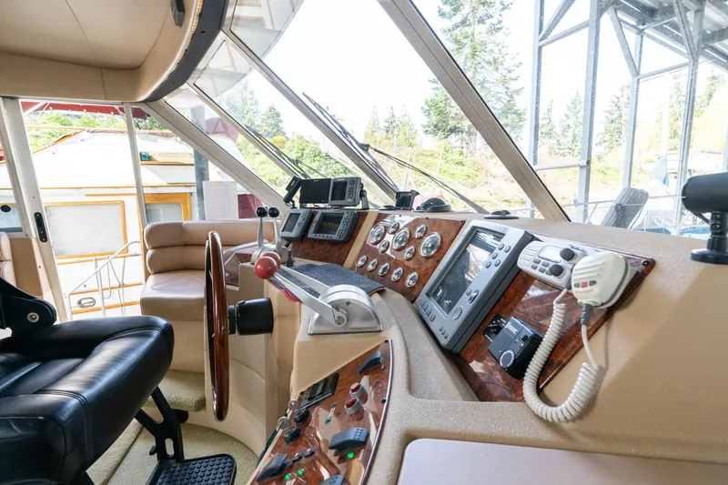 Slide: The Image of Pilothouse interior of 2003 Meridian 490, featuring navigation controls and leather seating. - 42