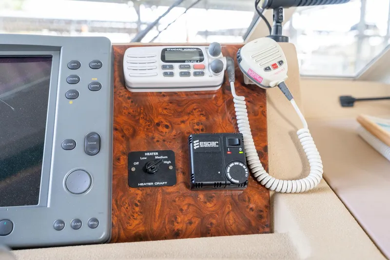 Slide: The Image of Control panel of a 2003 Meridian 490 Pilothouse with communication devices and navigation equipment. - 47