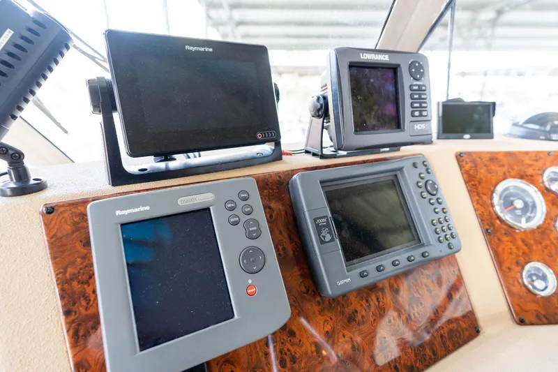 Slide: The Image of 2003 Meridian 490 Pilothouse dashboard with navigation equipment and controls. - 49