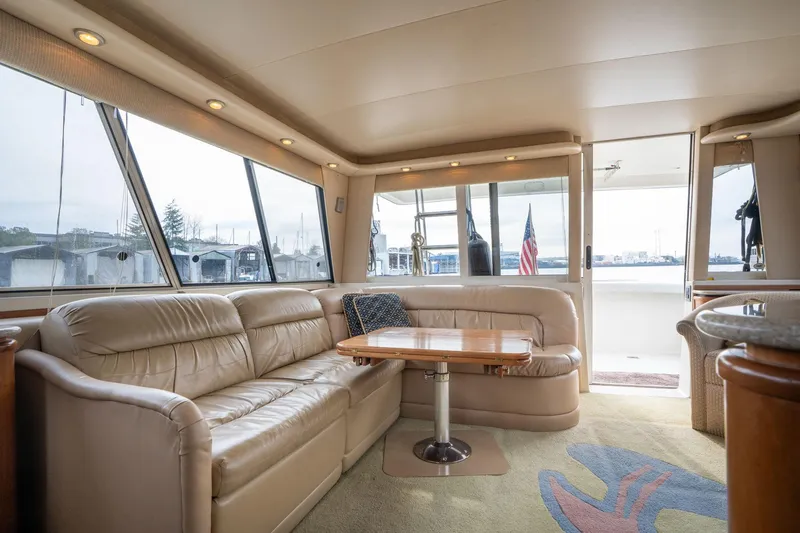 Slide: The Image of Luxurious interior of 2003 Meridian 490 Pilothouse yacht with leather seating and wooden table. - 5