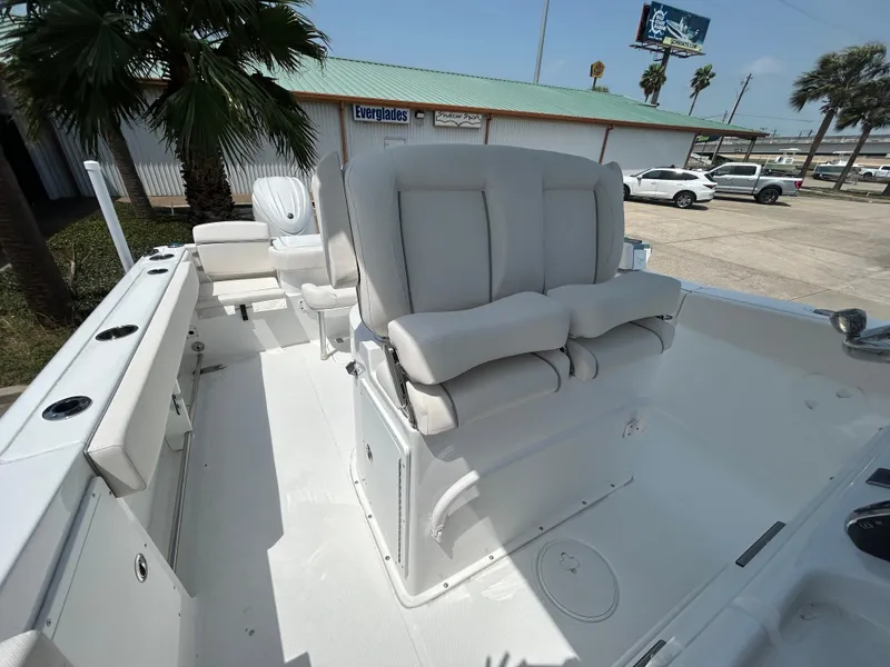 Slide: The Image of 2025 Sea Hunt Gamefish 27 boat interior with coffin box seating, white upholstery, and spacious deck. - 10