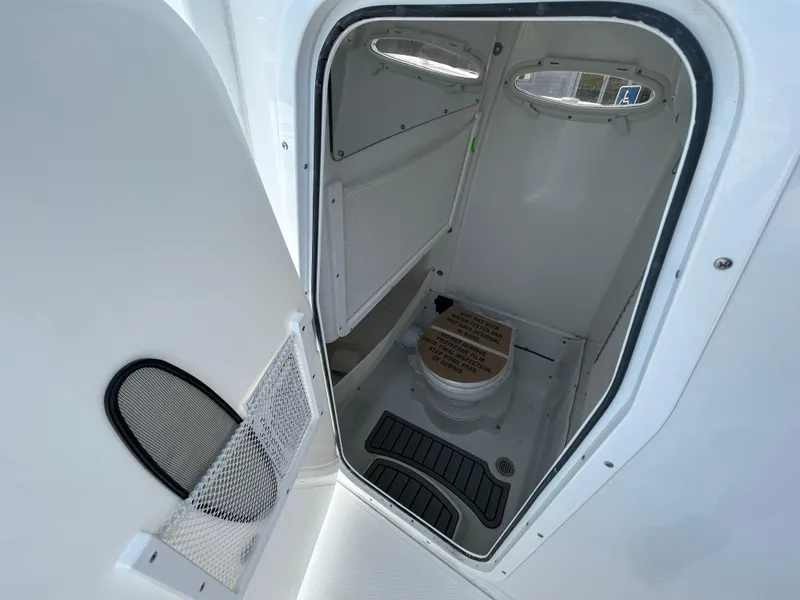 Slide: The Image of 2025 Sea Hunt Gamefish 27 boat interior with compact marine toilet. - 15