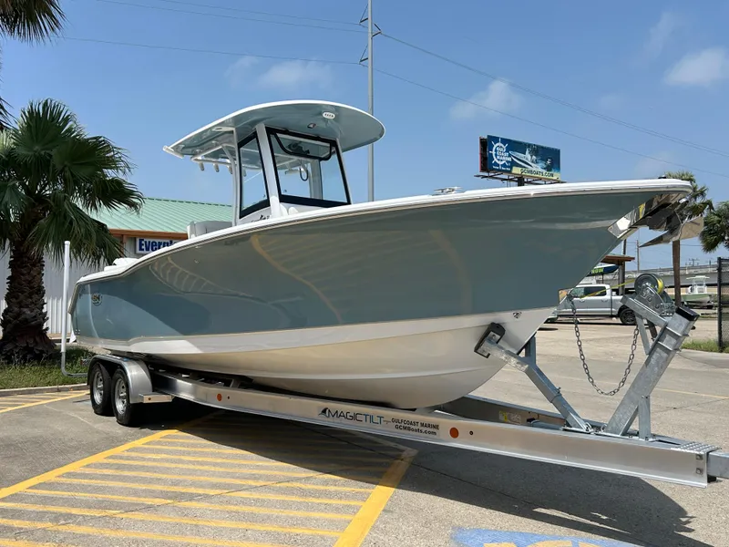 Slide: The Image of 2025 Sea Hunt Gamefish 27 with Coffin Box on trailer, parked outdoors. - 3