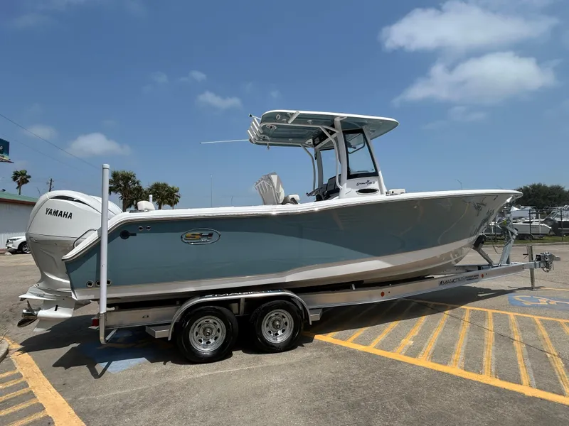 Slide: The Image of 2025 Sea Hunt Gamefish 27 with Coffin Box on trailer, parked outdoors. - 4