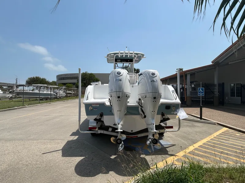 Slide: The Image of 2025 Sea Hunt Gamefish 27 with Coffin Box, dual engines, parked outdoors. - 5