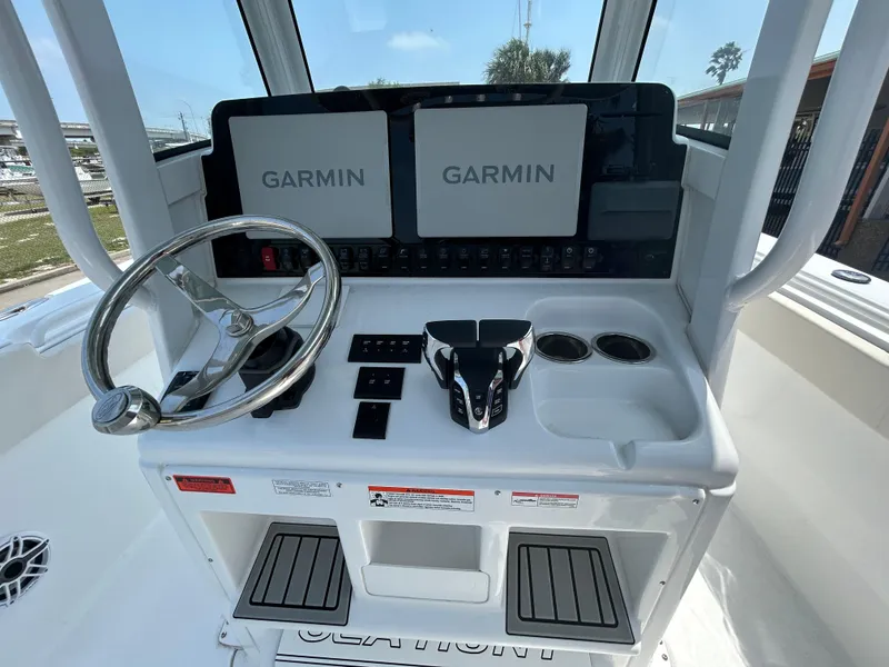 Slide: The Image of 2025 Sea Hunt Gamefish 27 helm with dual Garmin displays and steering wheel. - 9