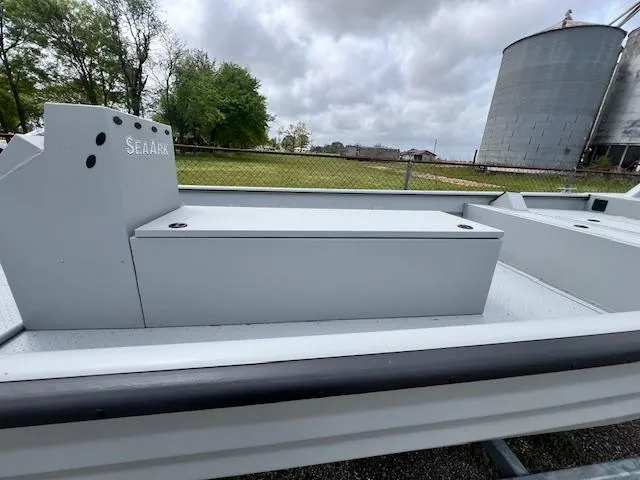 Slide: The Image of 2025 SeaArk 2472 Workhorse boat, gray deck, industrial setting, overcast sky. - 2