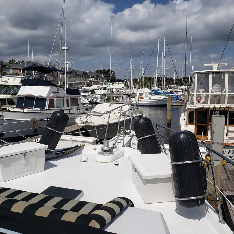 Slide: The Image of 1988 Viking 55 Motoryacht Walkaround docked among other boats in a marina. - 10