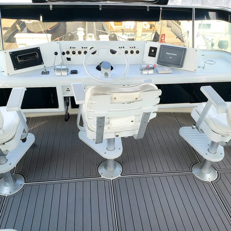 Slide: The Image of Cockpit of 1988 Viking 55 Motoryacht Walkaround with steering wheel and control panel. - 13