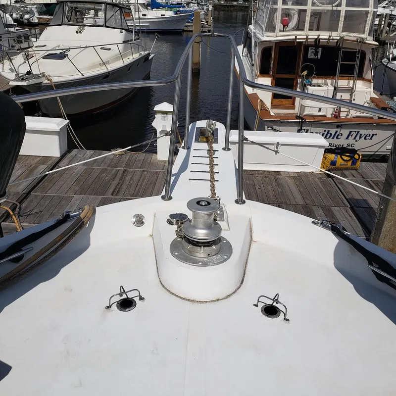 Slide: The Image of 1988 Viking 55 Motoryacht Walkaround at marina, showing bow and anchor chain. - 14