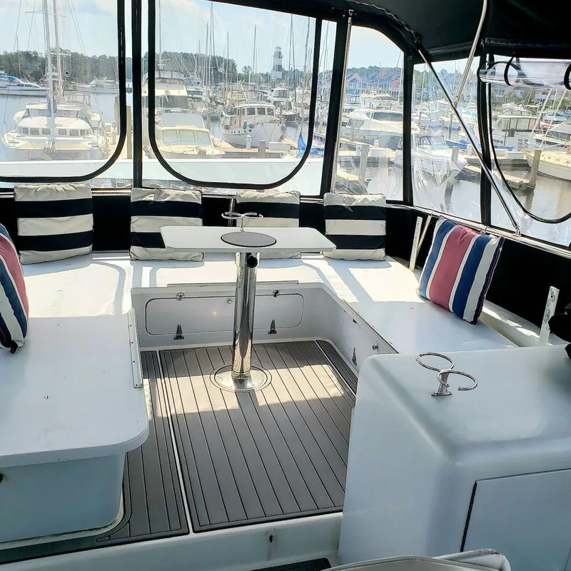 Slide: The Image of 1988 Viking 55 Motoryacht Walkaround interior with seating and marina view. - 16