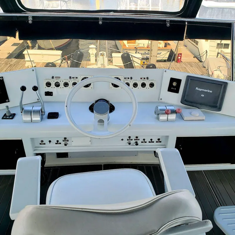 Slide: The Image of Helm of 1988 Viking 55 Motoryacht Walkaround with steering wheel and navigation controls. - 19