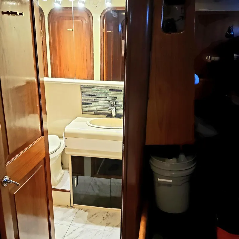 Slide: The Image of Interior of 1988 Viking 55 Motoryacht bathroom with wooden accents and modern sink. - 24