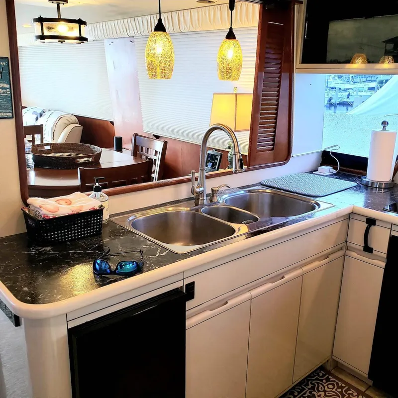 Slide: The Image of Interior of 1988 Viking 55 Motoryacht Walkaround with modern kitchen and dining area. - 25