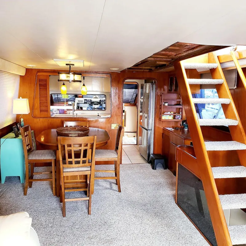 Slide: The Image of Interior of 1988 Viking 55 Motoryacht Walkaround with dining area and staircase. - 26