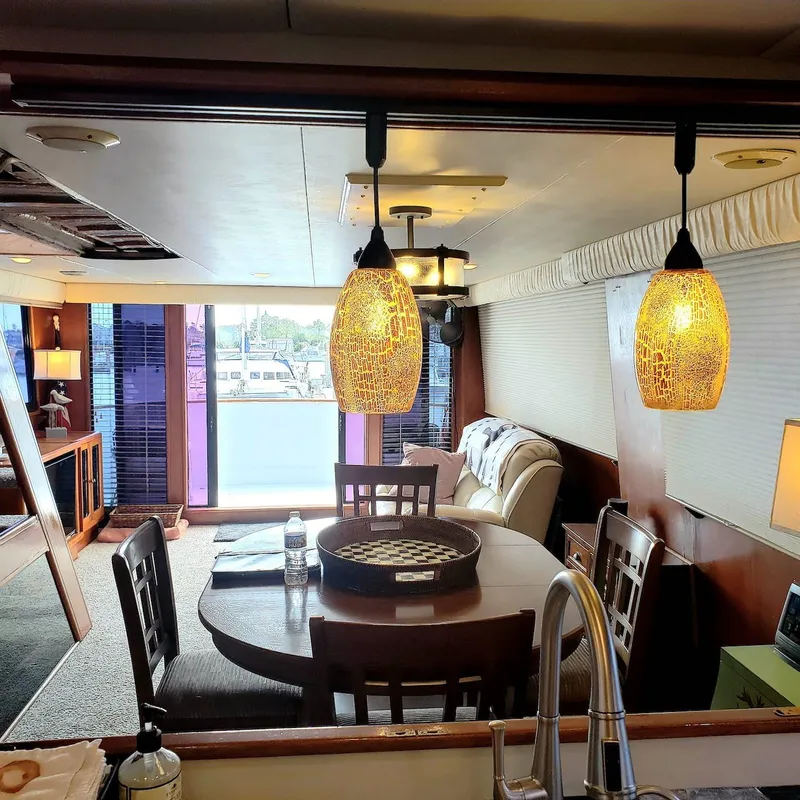 Slide: The Image of Interior of 1988 Viking 55 Motoryacht Walkaround with dining area and stylish lighting. - 27