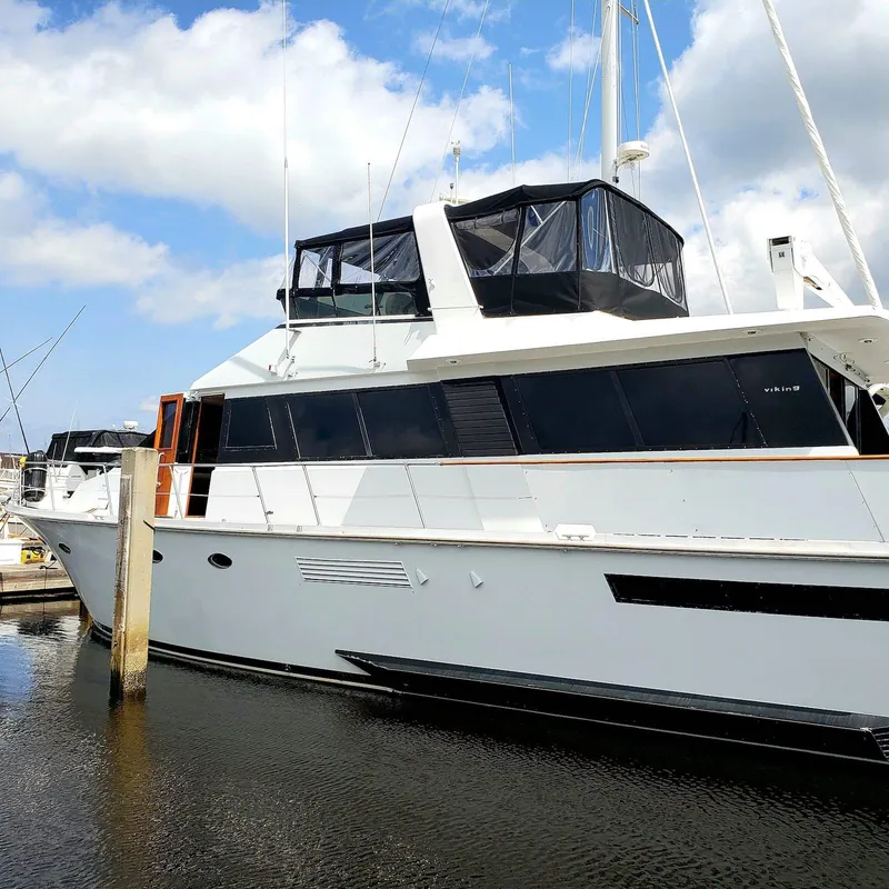 Slide: The Image of 1988 Viking 55 Motoryacht Walkaround docked under a blue sky. - 3