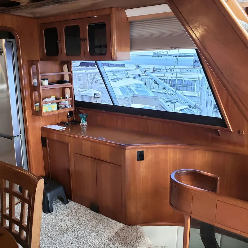 Slide: The Image of Interior of 1988 Viking 55 Motoryacht Walkaround with wooden cabinetry and large window view. - 31