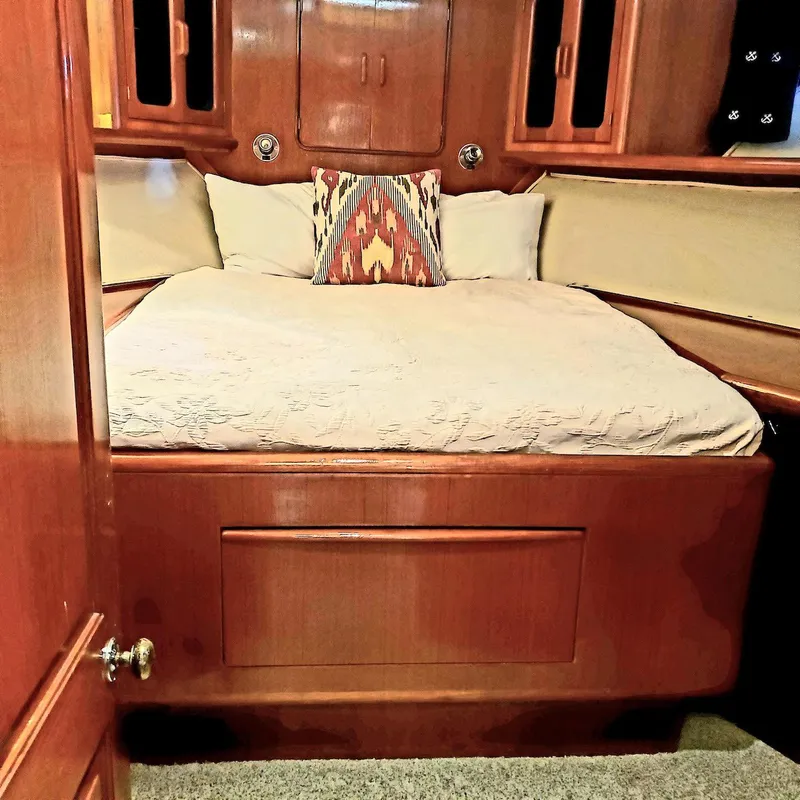 Slide: The Image of Cozy bedroom interior of 1988 Viking 55 Motoryacht Walkaround with wooden finish and decorative pillow. - 34