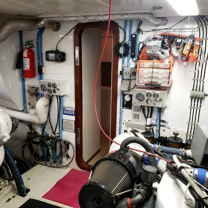 Slide: The Image of Engine room of a 1988 Viking 55 Motoryacht Walkaround, featuring control panels and equipment. - 35