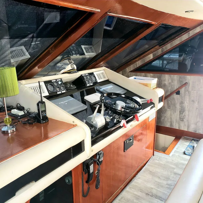 Slide: The Image of Helm of 1988 Viking 55 Motoryacht Walkaround with steering wheel and navigation controls. - 36