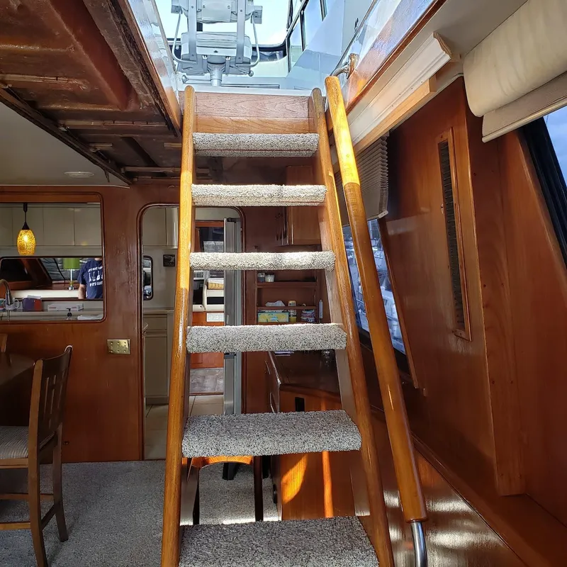 Slide: The Image of Interior of 1988 Viking 55 Motoryacht Walkaround with carpeted stairs and wooden paneling. - 39