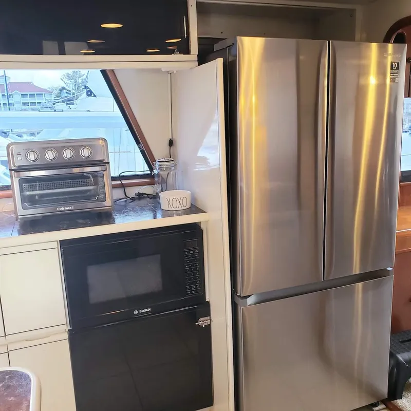 Slide: The Image of Kitchen area in a 1988 Viking 55 Motoryacht with modern appliances. - 40